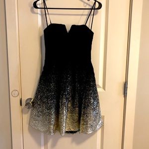 Sweet, short black and gold dress great for a dance or the club